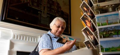 Woman looking at postcards in Bruce Castle Museum