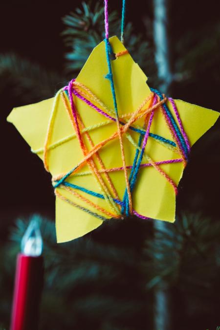 Childs Christmas star decoration made of card and string