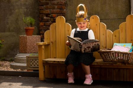 Girl reading a book about castles outside Bruce Castle Museum