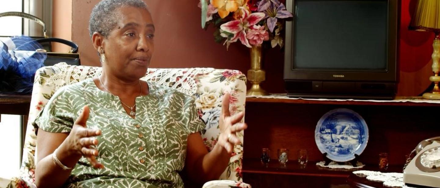 Woman sat in armchair next to tv