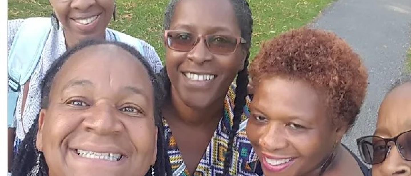 5 women taking a selfie in a park