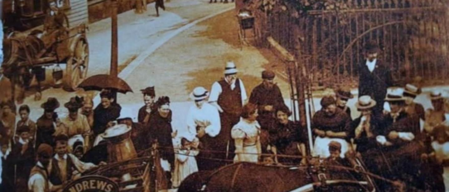 Image of edwardian tottenham with croud gathered round what appears to be a horse drawn milk cart