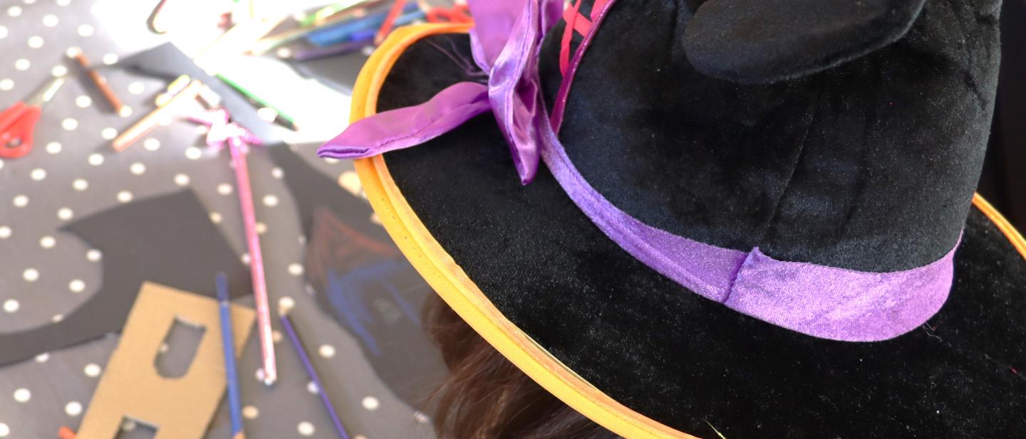 Young girl in black hat doing craft workshop