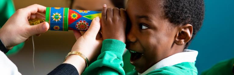 Pupil playing with a kaldioscope