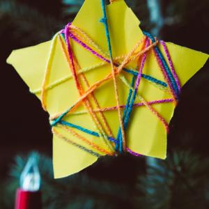 Childs Christmas star decoration made of card and string