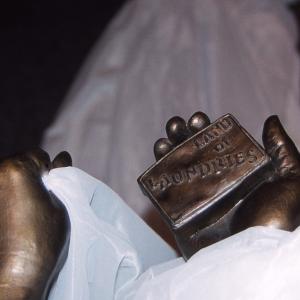 bronze sculpture of hand holding bar of soap