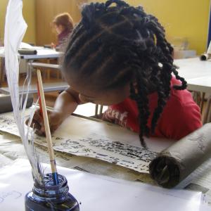 child doing scroll and calligraphy activity 