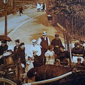 Image of edwardian tottenham with croud gathered round what appears to be a horse drawn milk cart
